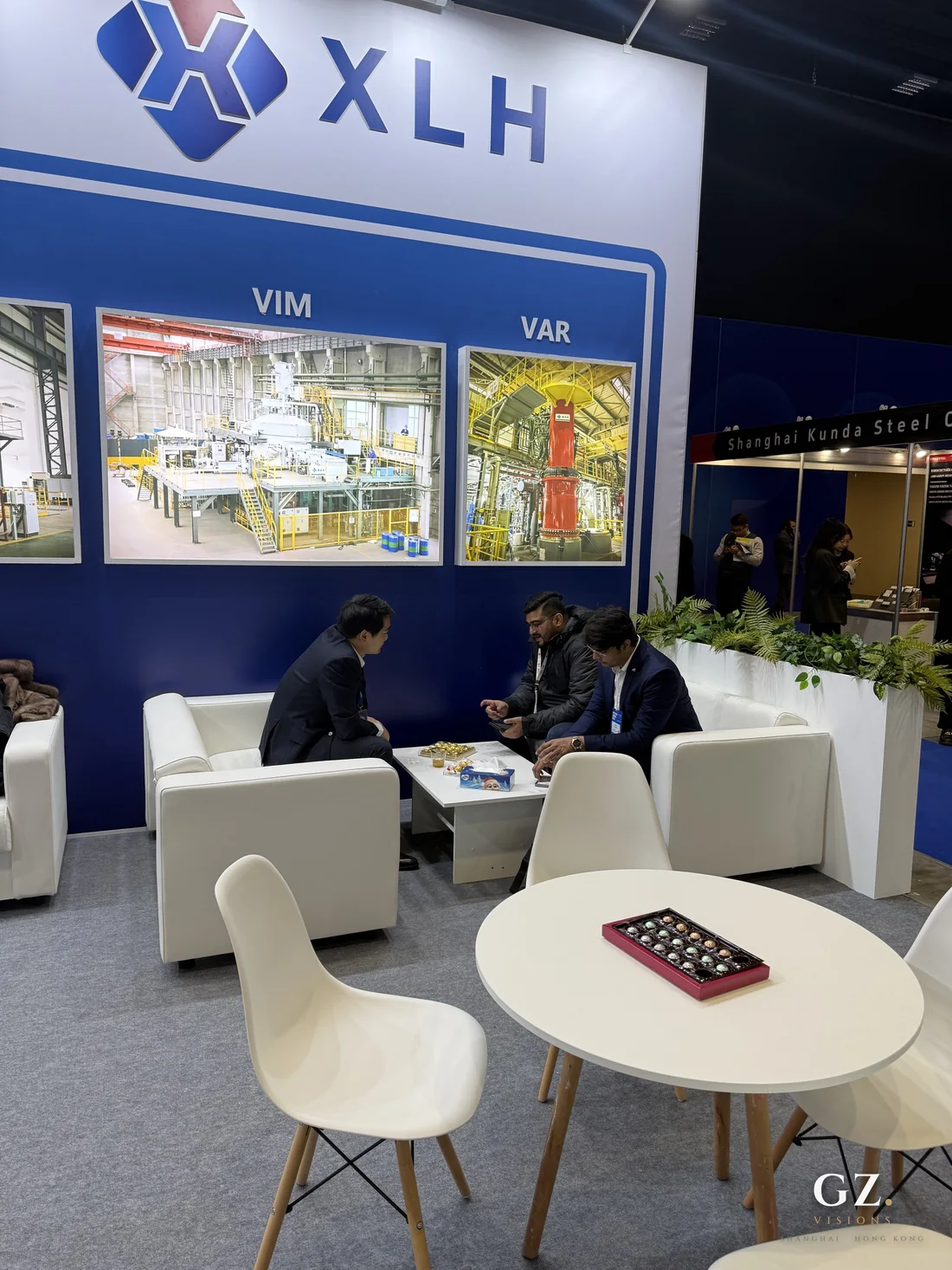 Seating area of the stand with two visitors in conversation